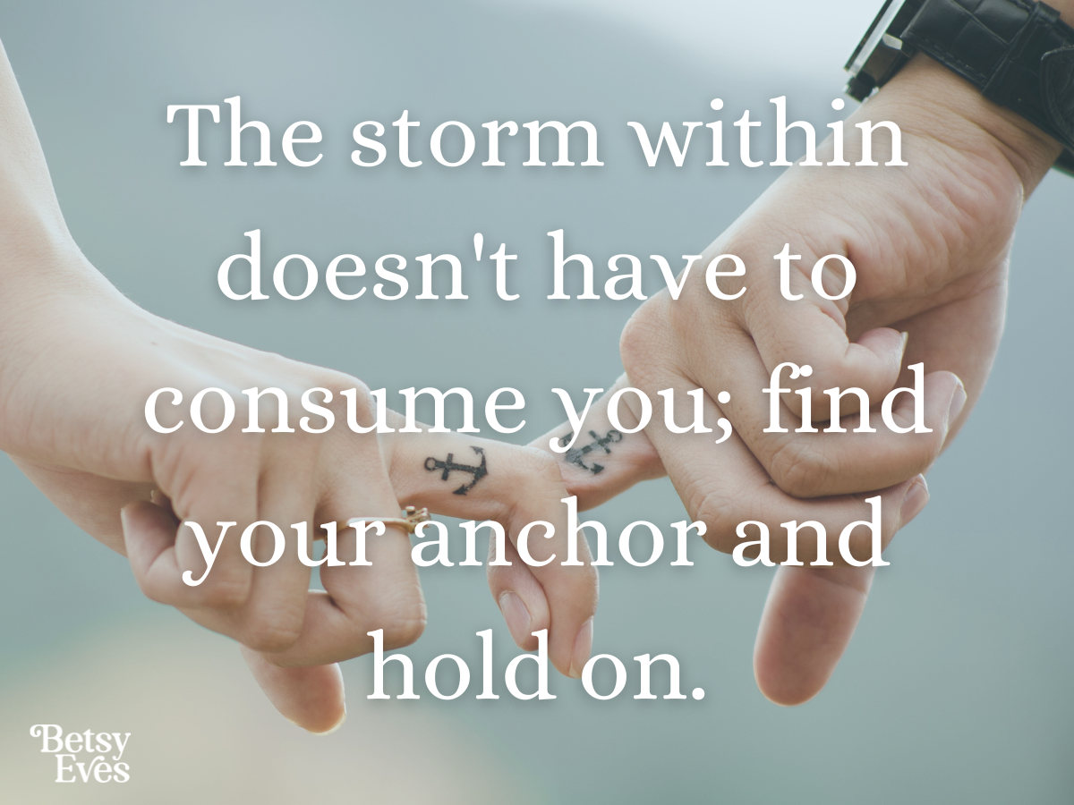 Two hands with their index fingers linked, each displaying an anchor tattoo, symbolizing the quote 'The storm within doesn't have to consume you; find your anchor and hold on.
