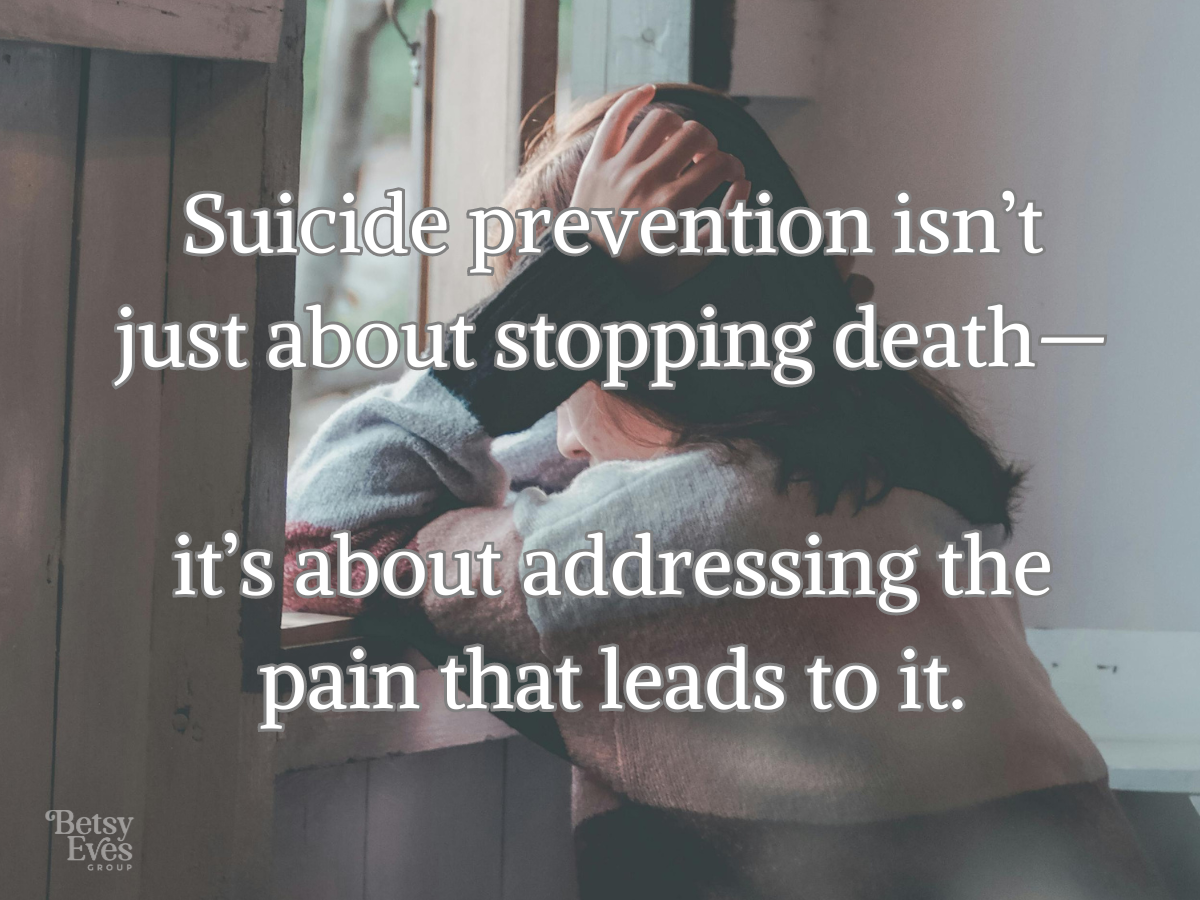 g out a window with text overlay that reads: Suicide prevention isn't just about stopping death - it's about addressing the pain that leads to it. 